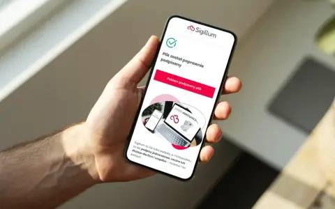 Dłoń trzyma smartfon z potwierdzeniem podpisu elektronicznego. Sigillum oferuje podpisy dla każdego obywatela.