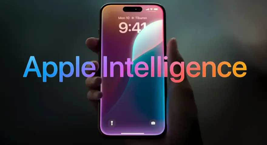 Dłoń trzyma smartfon z ekranem blokady, na którym widnieje napis "Apple Intelligence" w tęczowych barwach.